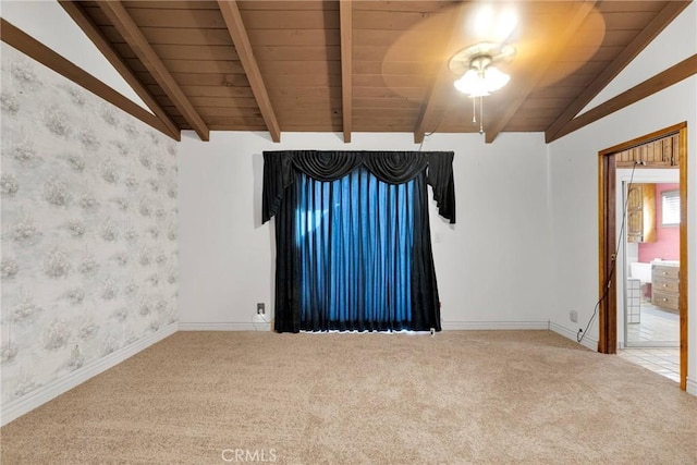 carpeted spare room featuring lofted ceiling with beams and wood ceiling