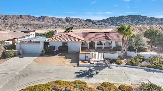 mediterranean / spanish house featuring a garage and a mountain view