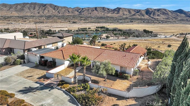 birds eye view of property with a mountain view