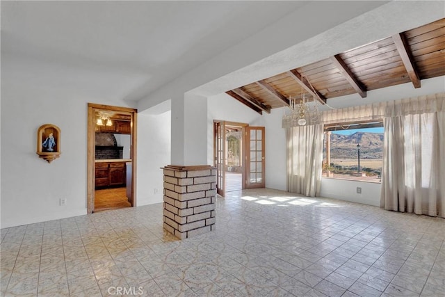 unfurnished living room with french doors, an inviting chandelier, wooden ceiling, and lofted ceiling with beams