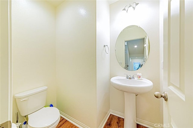 bathroom featuring toilet and hardwood / wood-style flooring