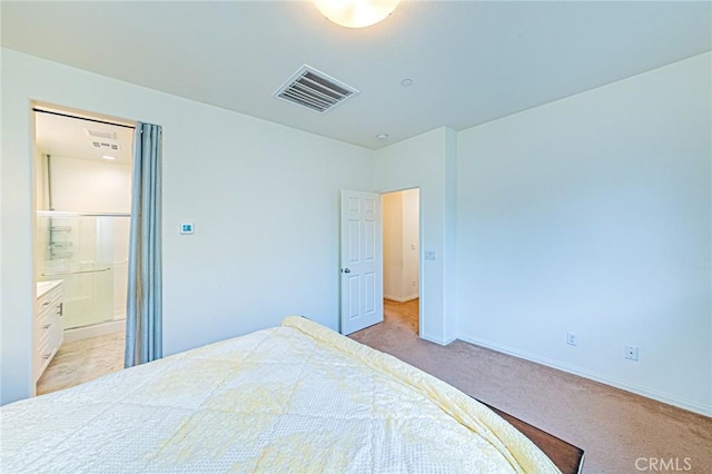 carpeted bedroom with ensuite bath