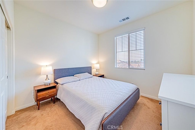 bedroom featuring a closet and light carpet