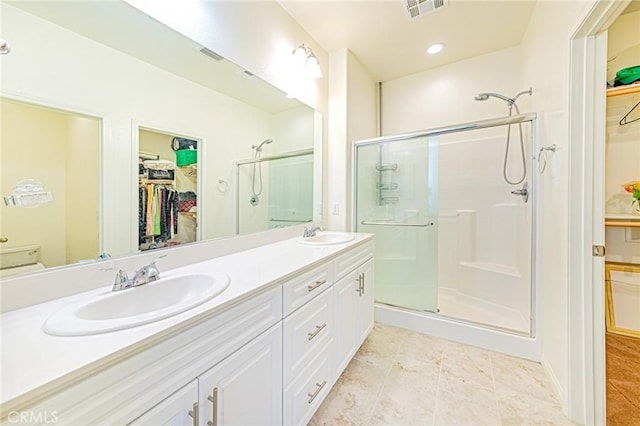 bathroom with walk in shower, vanity, and toilet