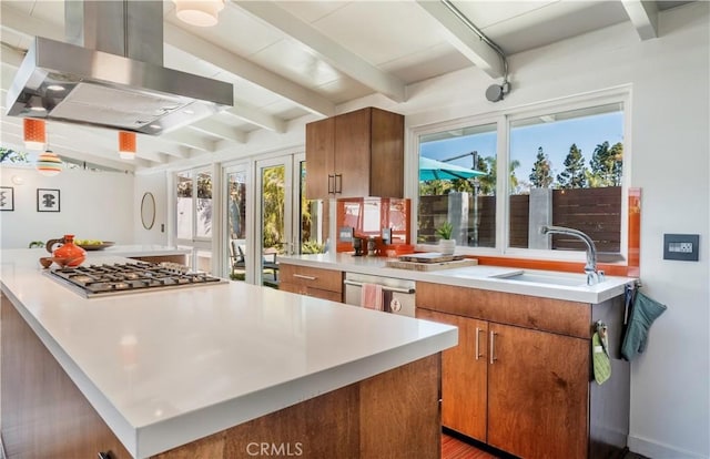 kitchen with island range hood, stainless steel appliances, a center island, lofted ceiling with beams, and sink