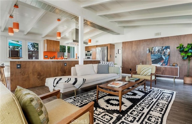 living room featuring dark wood-type flooring, wooden walls, and lofted ceiling with beams