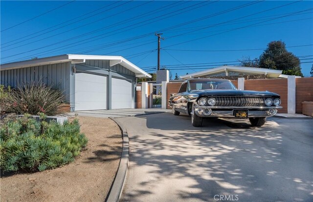 view of front facade with a garage and an outbuilding