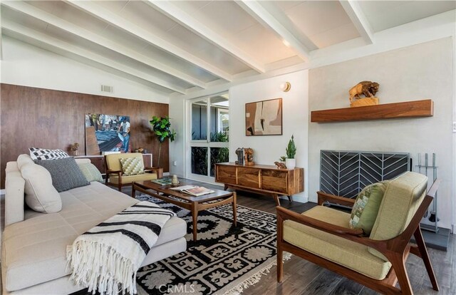 interior space featuring lofted ceiling with beams, wood walls, and wood-type flooring