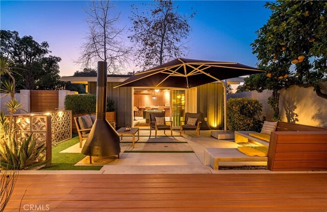 deck at dusk with an outdoor hangout area