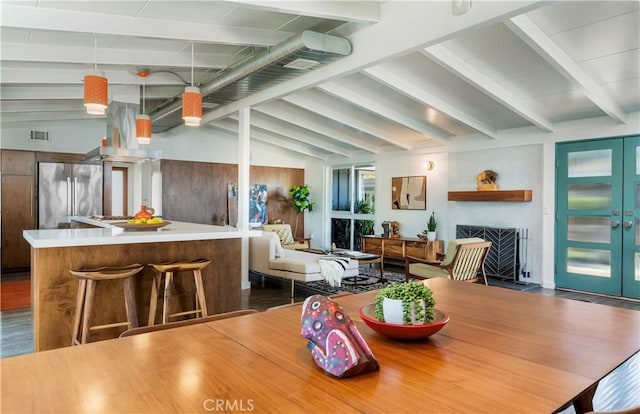 dining room with dark hardwood / wood-style flooring and lofted ceiling with beams