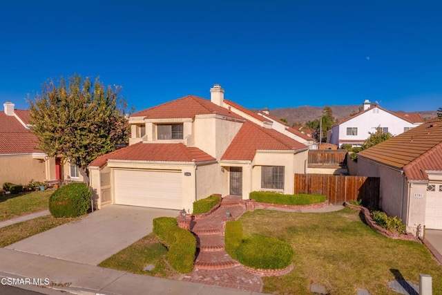 mediterranean / spanish-style house with a front yard and a garage