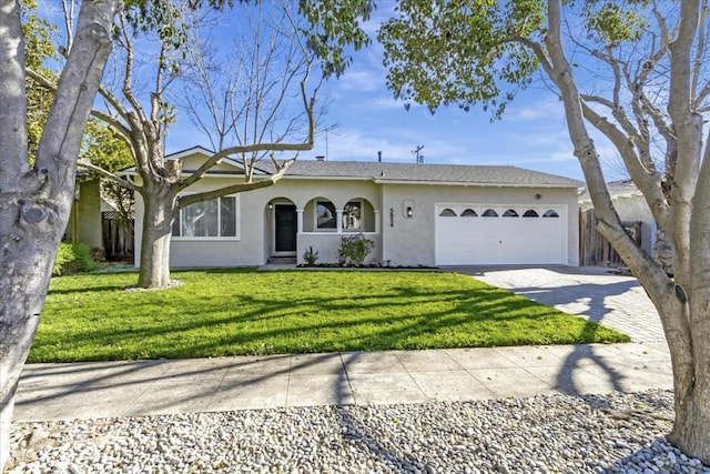 ranch-style house featuring a front yard and a garage