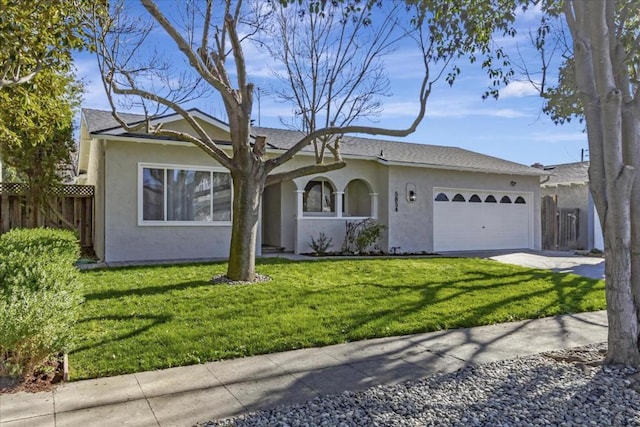 ranch-style house featuring a front yard and a garage