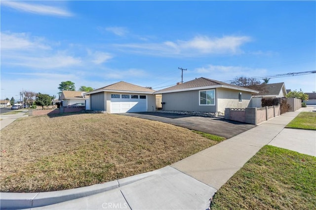 ranch-style home with a garage and a front lawn