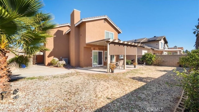 back of house with a patio