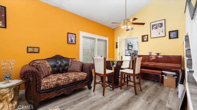 sitting room featuring vaulted ceiling, ceiling fan, and light hardwood / wood-style floors