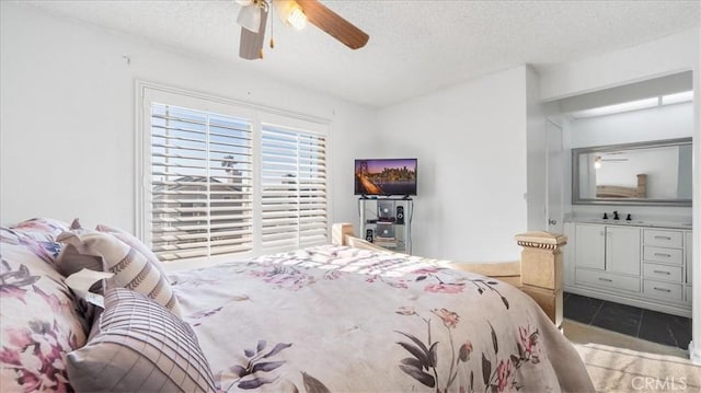 tiled bedroom featuring a textured ceiling and ceiling fan