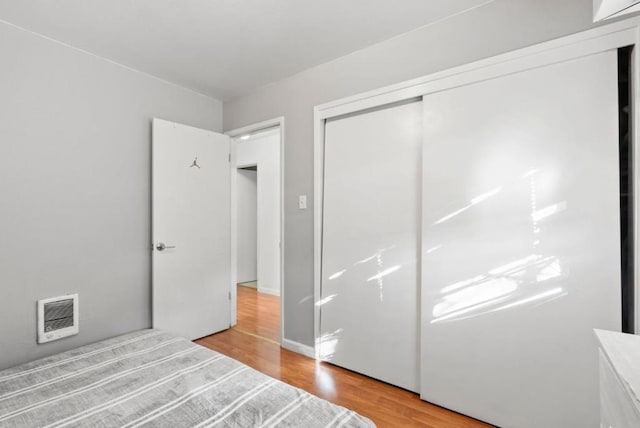 unfurnished bedroom featuring a closet and light wood-type flooring