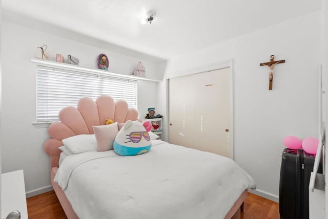 bedroom featuring a closet and light wood-type flooring