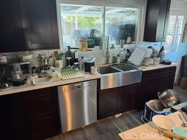 kitchen with dark hardwood / wood-style flooring, dishwasher, sink, and a wealth of natural light