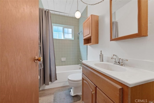 full bathroom featuring toilet, vanity, and shower / bathtub combination with curtain