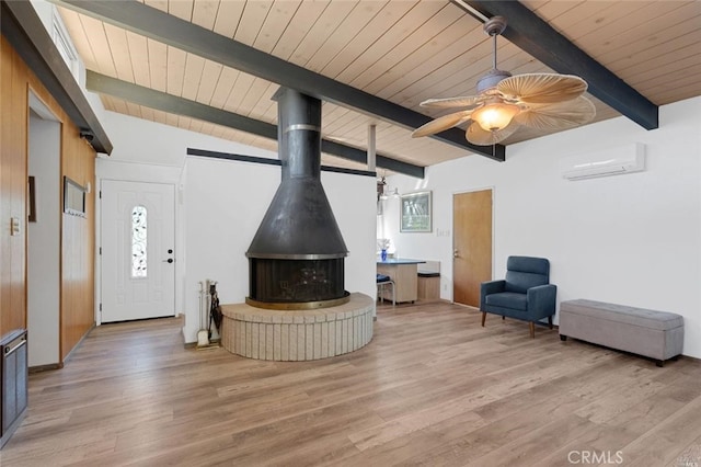 living room featuring wood ceiling, a wall mounted air conditioner, light hardwood / wood-style flooring, a wood stove, and beamed ceiling