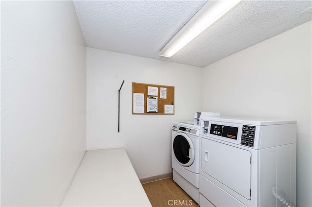 laundry area with a textured ceiling and independent washer and dryer