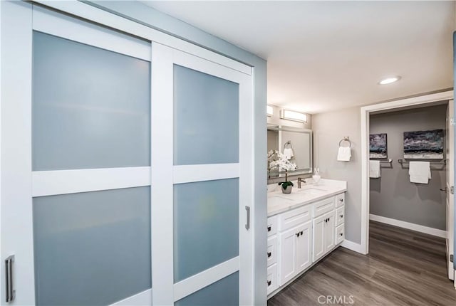 bathroom featuring hardwood / wood-style flooring and vanity