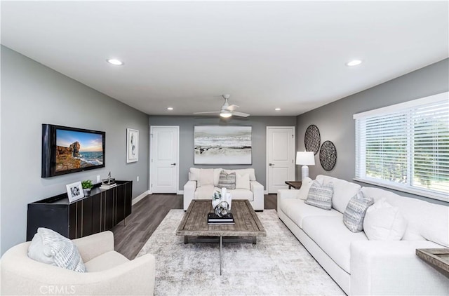 living room featuring hardwood / wood-style floors and ceiling fan