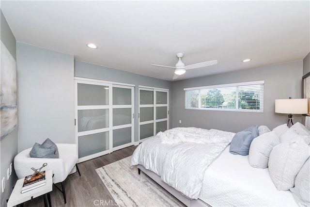 bedroom with dark hardwood / wood-style flooring and ceiling fan