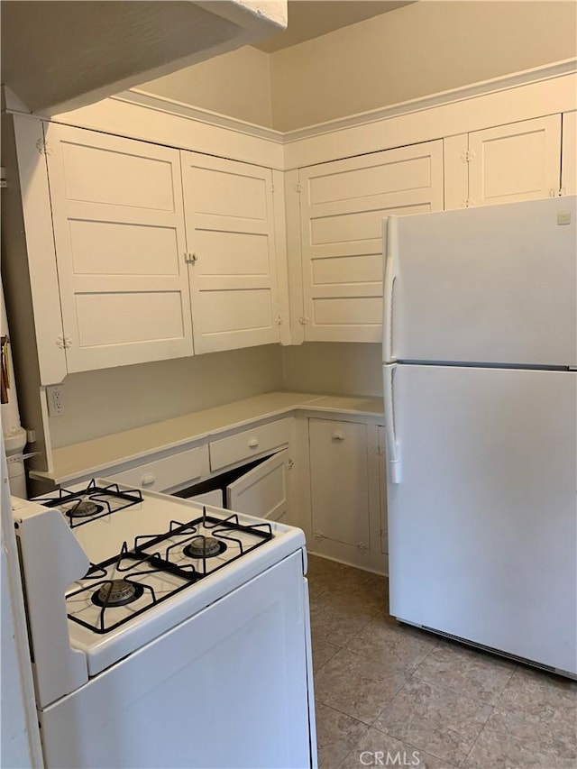 kitchen with white appliances and white cabinetry