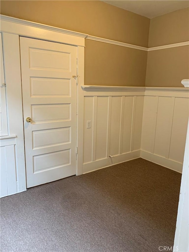 interior space with dark colored carpet