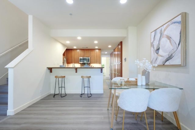 dining space with light hardwood / wood-style floors