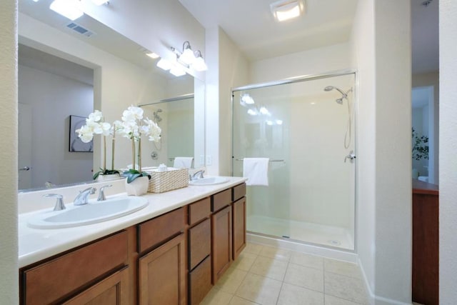 bathroom with an enclosed shower, vanity, and tile patterned floors