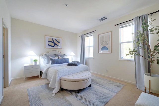 bedroom featuring light carpet