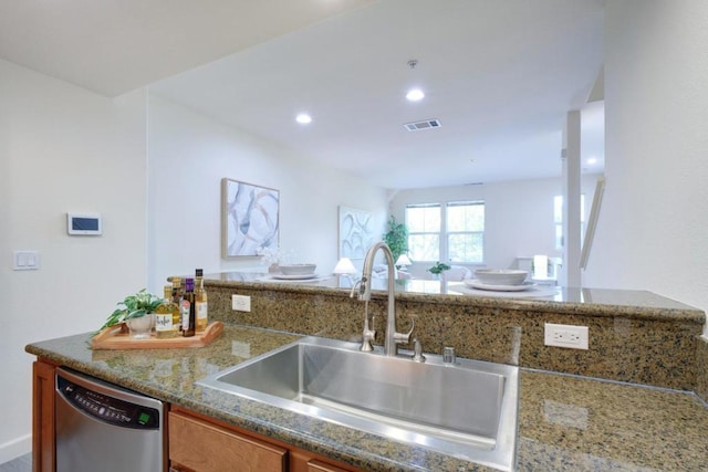 kitchen featuring sink, stainless steel dishwasher, and stone counters