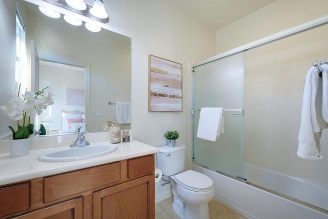 full bathroom with toilet, bath / shower combo with glass door, tile patterned flooring, and vanity