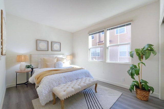 bedroom with dark hardwood / wood-style floors