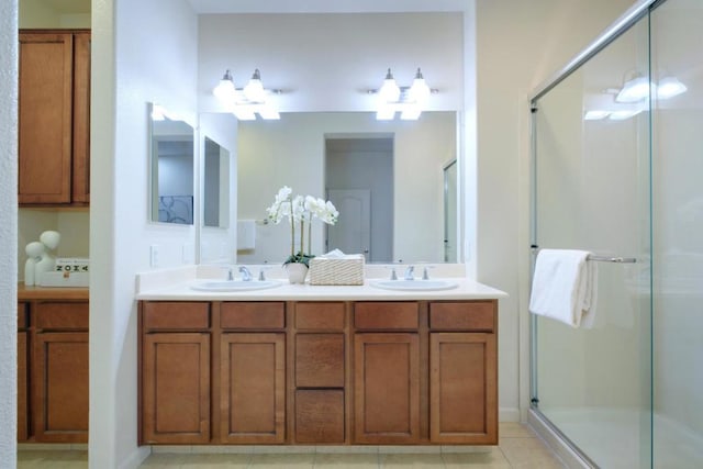 bathroom featuring tile patterned floors, an enclosed shower, and vanity