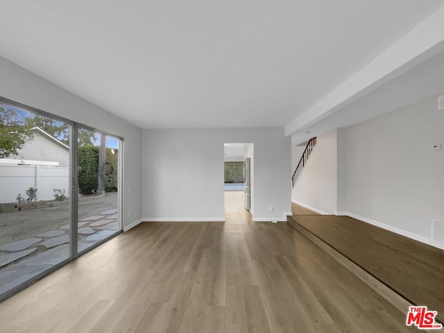 unfurnished living room with wood-type flooring