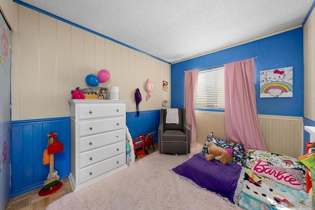 bedroom with a textured ceiling and ornamental molding