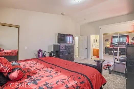 carpeted bedroom featuring vaulted ceiling