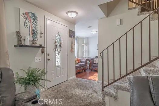 foyer entrance featuring carpet