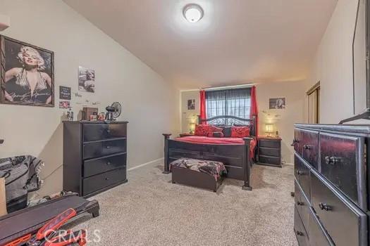 carpeted bedroom featuring vaulted ceiling