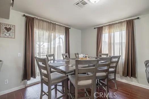 dining room with dark wood-type flooring and plenty of natural light