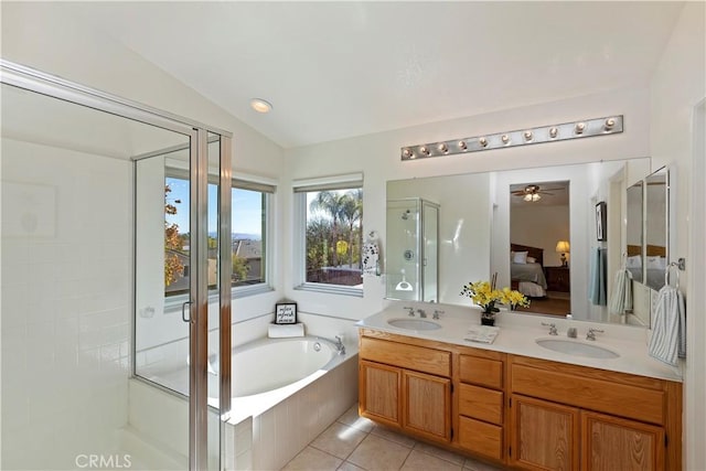 bathroom with vaulted ceiling, tile patterned flooring, ceiling fan, separate shower and tub, and vanity