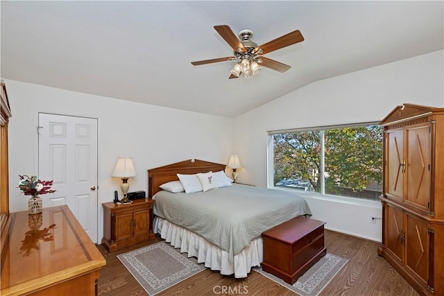 bedroom featuring ceiling fan, vaulted ceiling, and dark hardwood / wood-style floors