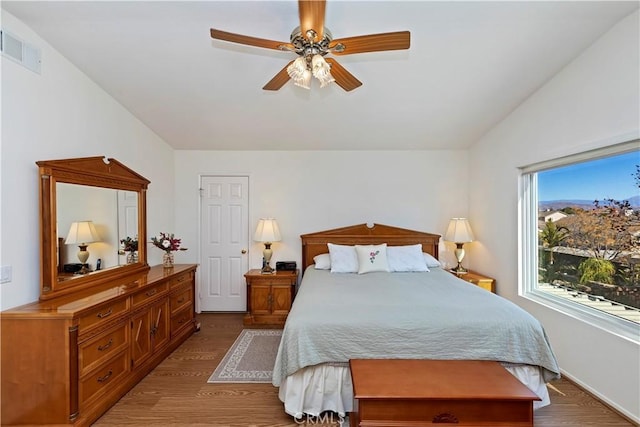 bedroom featuring lofted ceiling, hardwood / wood-style flooring, and ceiling fan