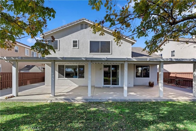 back of property with a patio and a yard