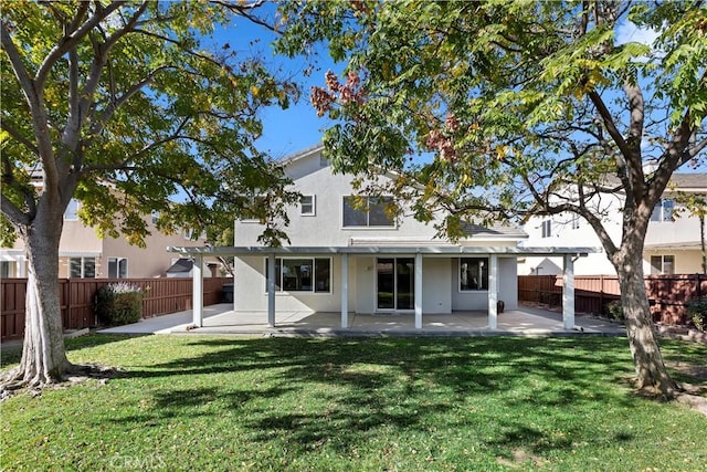 back of property featuring a yard and a patio area